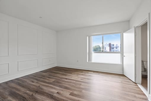 Large-Size Bedroom with Bathroom, Vinyl Flooring, and Windows