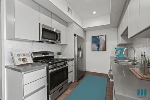 a kitchen with white cabinetry and stainless steel appliances