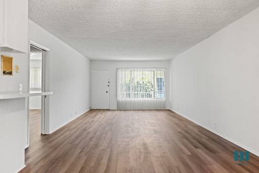 A room with wooden floors and white walls.