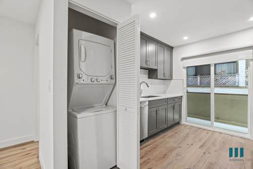 A modern kitchen with a dishwasher and a refrigerator.