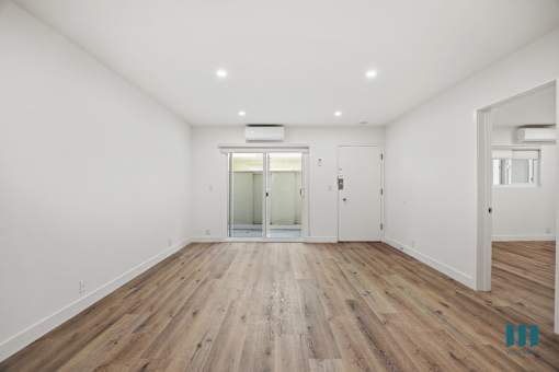 A room with wooden floors and white walls.