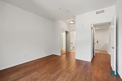 Bedroom with Bathroom, Mirrored Closet, and Vinyl Flooring