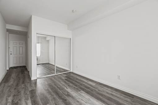 Bedroom with Mirrored Closet and Vinyl Flooring