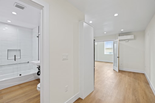 Unit with Vinyl Flooring and Hall Bathroom with Full-Size Bathtub