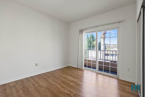 Bedroom with Mirrored Closet and Balcony