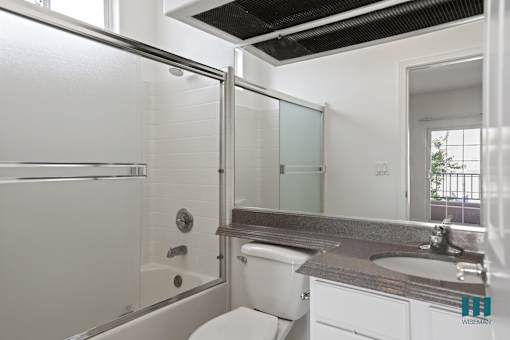 Bathroom with Shower Bath with Glass Door and Vanity with Cabinet Storage