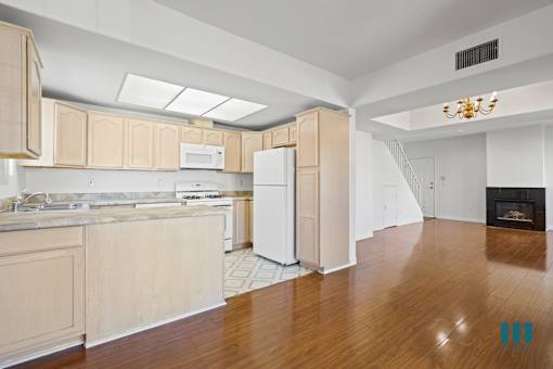 Kitchen with Countertop Bar, Dining Room, and Living Room