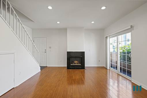 Townhome-Style Living Room with Electric Fireplace, Vinyl Flooring, and Balcony