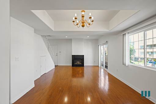Spacious Dining and Living Room with Vinyl Flooring, Electric Fireplace, and Lots of Windows
