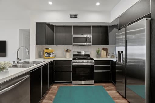 Spacious Kitchen with Stainless-Steel Refrigerator, Stove, Microwave Oven, and Dishwasher