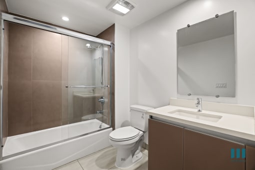 Bathroom with Shower Bath with Glass Door and Vanity Cabinet Storage