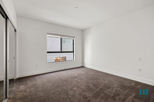 Bedroom with Mirrored Closet and Windows