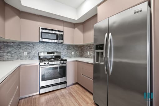 Kitchen with Stainless-Steel Refigerator, Dishwasher, Stove, and Microwave Oven