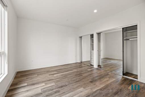 Bedroom with Two Mirrored Closets with Built-In Organizers
