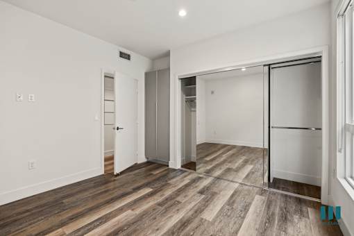 Bedroom with Mirrored Closet, Vinyl Flooring, and Recessed Lighting