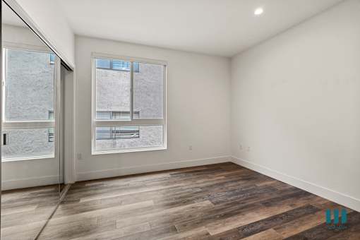 Bedroom Vinyl Flooring, Large-Size Windows, and Recessed Lighting