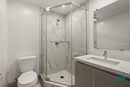 Bathroom with Stand-Up Shower with Glass Door and Vanity Cabinet Storage