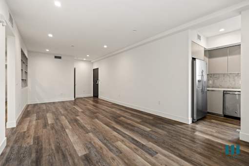 Open-Concept Dining and Living Room with Vinyl Flooring and Recessed Lighting