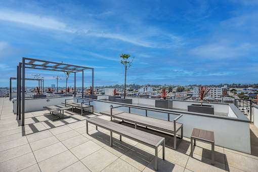 A rooftop patio with a table and chairs.