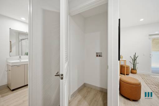 A bathroom with a white door and a white sink.