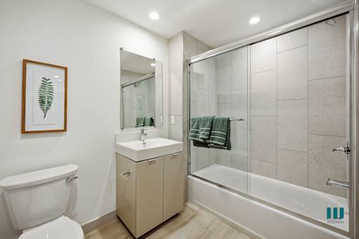 Bathroom with Shower Bath with a Glass Door and Vanity Cabinet Storage
