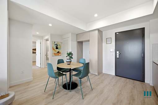 A dining room with a round table and chairs.