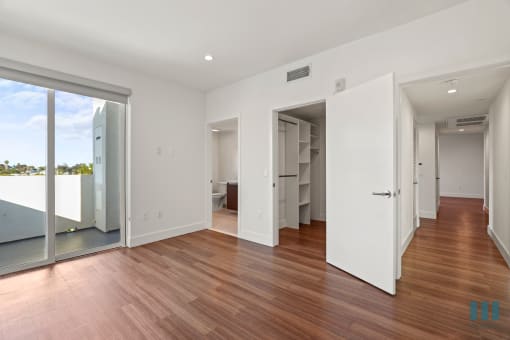 Bedroom with Bathroom, Walk-In Closet, and Patio