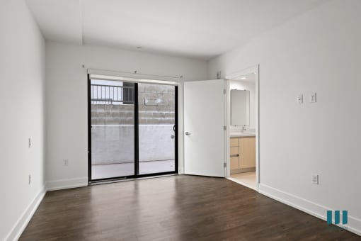 Bedroom with Vinyl Flooring, Bathroom, and Patio