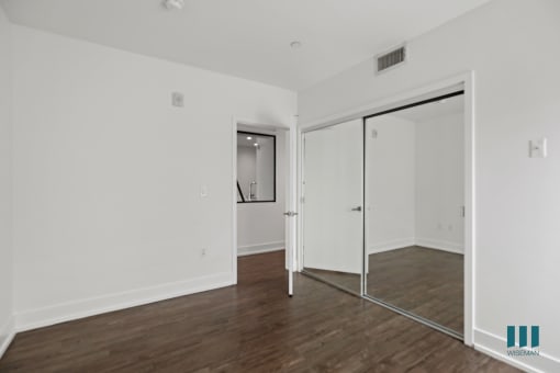Bedroom with Mirrored Closet, Vinyl Flooring, and Recessed Lighting