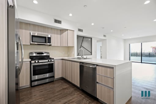 Kitchen with Energy-Efficient Stainless Appliances and Countertop Bar