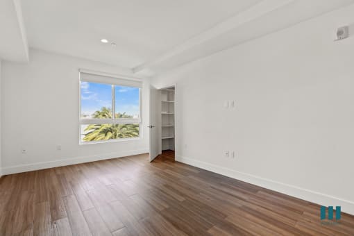 Spacious Bedroom with Vinyl Flooring, Recessed Lighting, and Walk-In Closet with Shelving