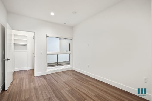 Bedroom with Vinyl Flooring, Walk-In Closet, and Large-Size Windows