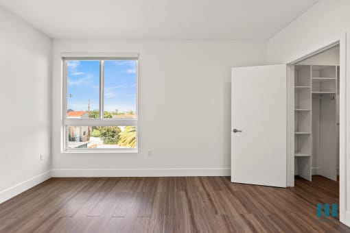 Bedroom with Walk-In Closet with Built-In Organizers and Large-Size Windows