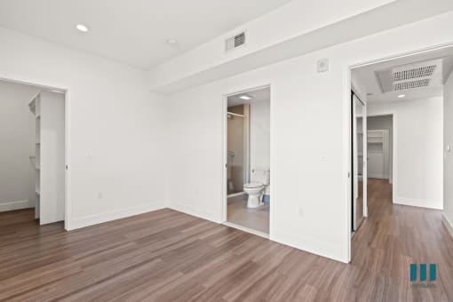 Bedroom with Vinyl Flooring, Recessed Lighting, Walk-In Closet, and Bathroom