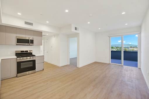 A modern kitchen with a stainless steel oven and microwave.