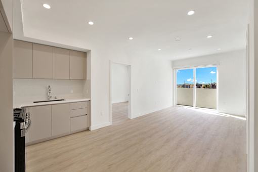 A modern kitchen with a large window overlooking the city.