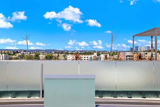 A modern building with a glass wall and a white box in front of it.