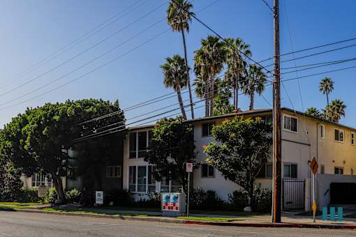 A house with a white fence and a sign that says no parking.