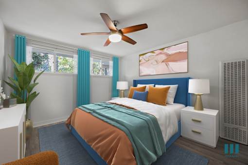 A bedroom with a bed, a ceiling fan, and a painting on the wall.
