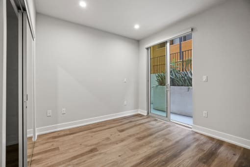 Bedroom with Mirrored Closet, Vinyl Flooring, and Balcony with Private Entrance