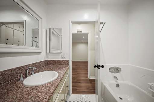 a bathroom with a sink and a shower and a bath tub