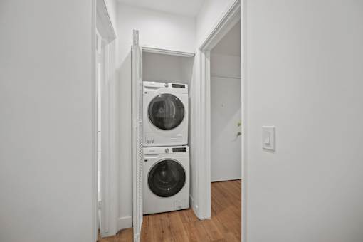 an empty laundry room with a washing machine and a dryer