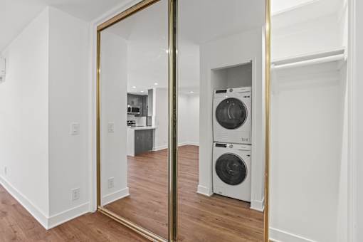 a reflection of a laundry room with a washing machine in a mirror