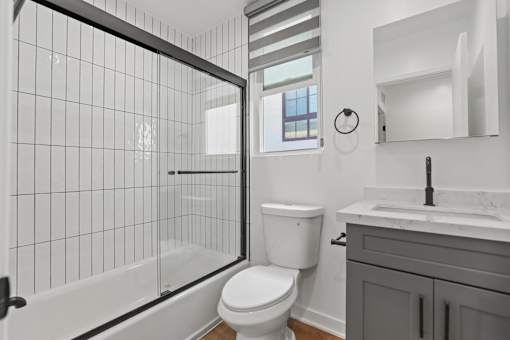 a white bathroom with a shower and a toilet