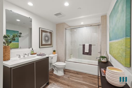 Large-Size Bathroom with Bathtub with Glass Door and Vanity Cabinet Storage