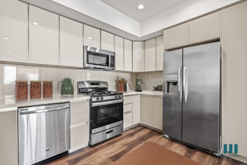 Kitchen with Stainless-Steel Refrigerator, Dishwasher, Stove, and Microwave Oven