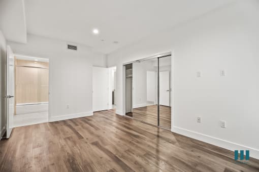 Bedroom with Mirrored Closet, Bathroom, Vinyl Flooring, and Recessed Lighting
