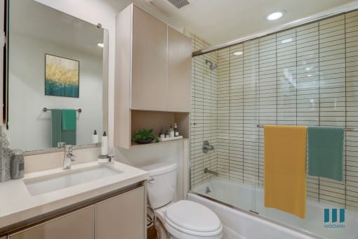 Bathroom with Shower-Bath with Glass Door and Cabinet Storage