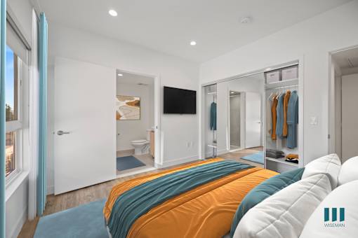Bedroom with Closet with Built-In Shelving, Bathroom, and Large-Size Windows