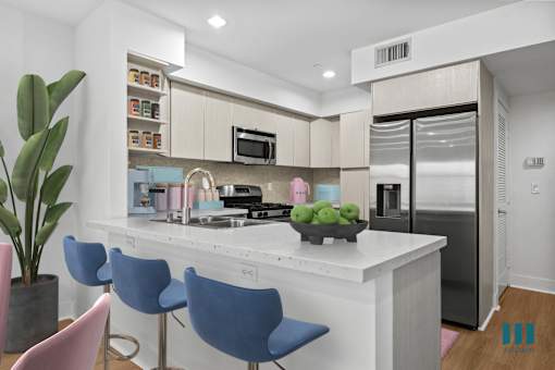 Open-Concept Kitchen with Energy-Efficient Appliances and Countertop Bar